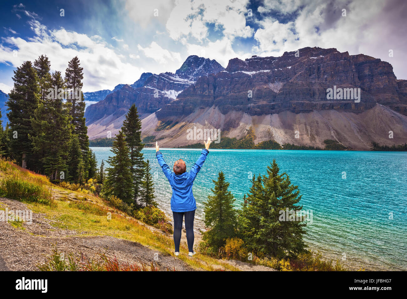 Middle-aged woman in awe of Rocky Mountains Stock Photo