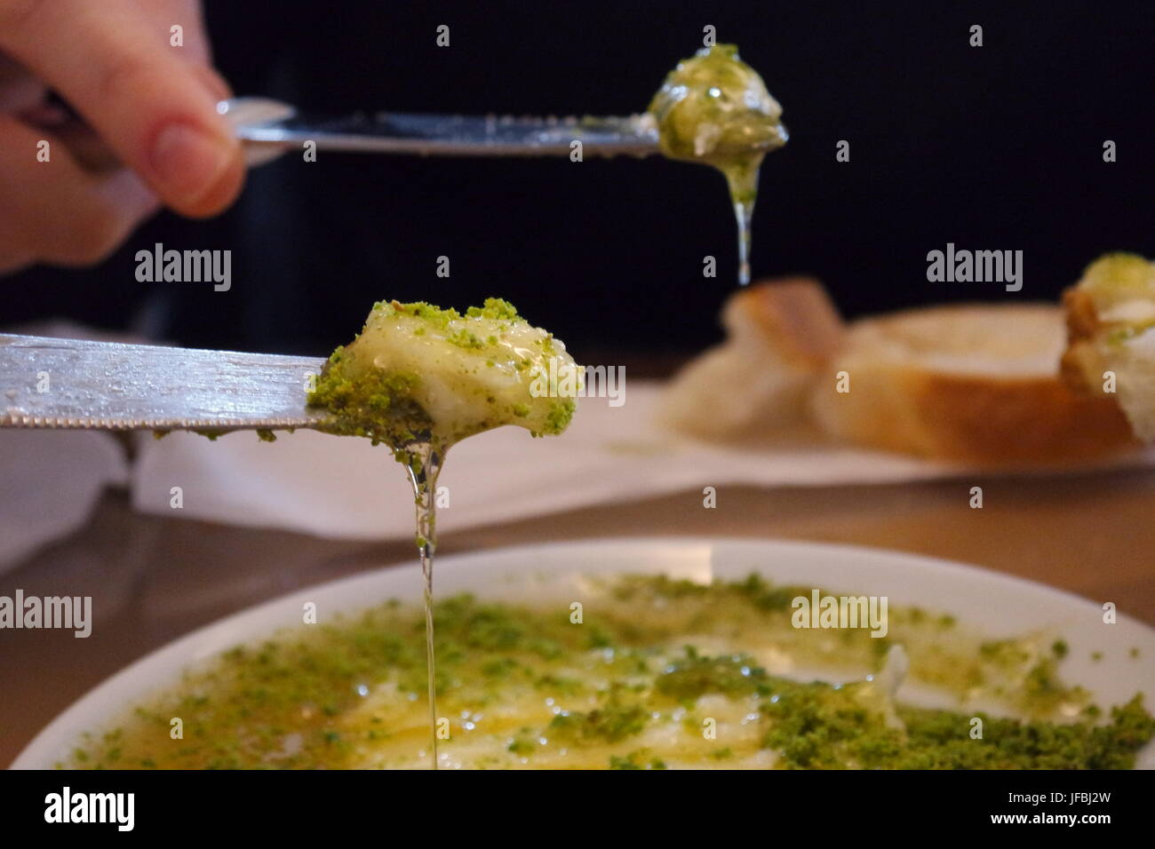 Butter cream and pistachios spread on bread for breakfast Stock Photo