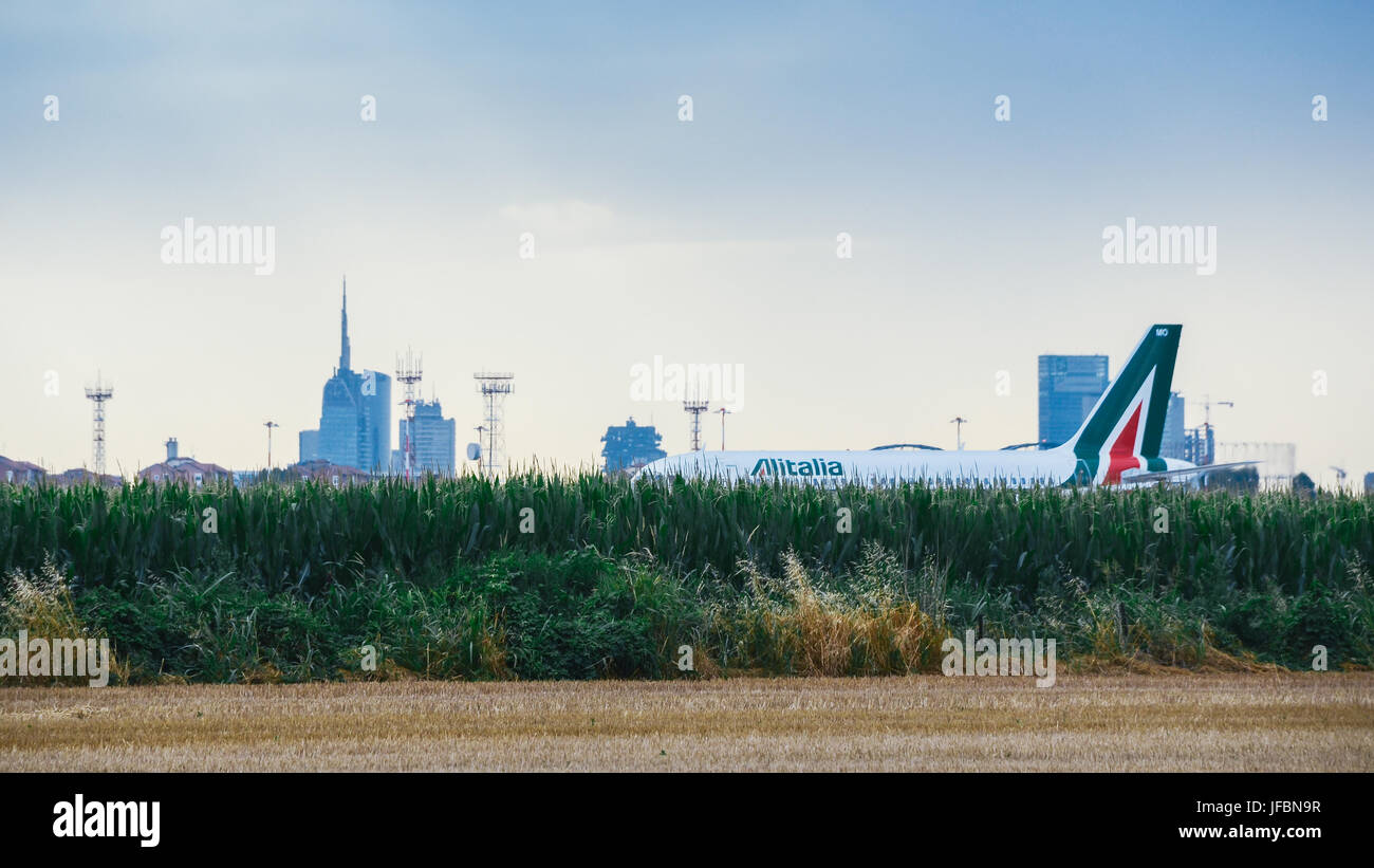 Milan, Italy - June 29th, 2017: Alitalia commercial airplane taxis at Milan's Linate Airport in Italy during a cloudy day Stock Photo