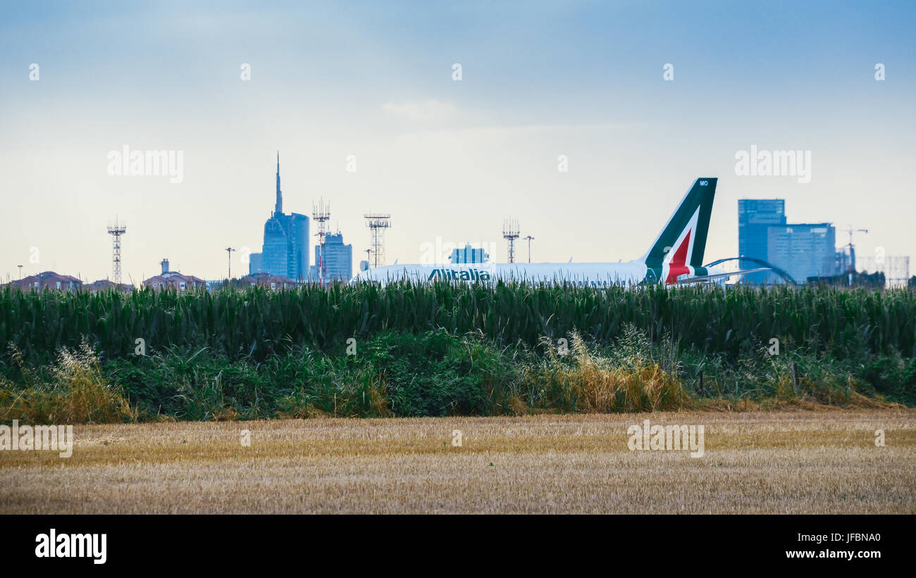 Milan, Italy - June 29th, 2017: Alitalia commercial airplane taxis at Milan's Linate Airport in Italy during a cloudy day Stock Photo