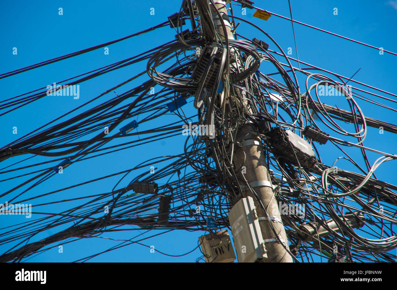 Close up of an entangled power lines in a an beautiful blue sky in the ...