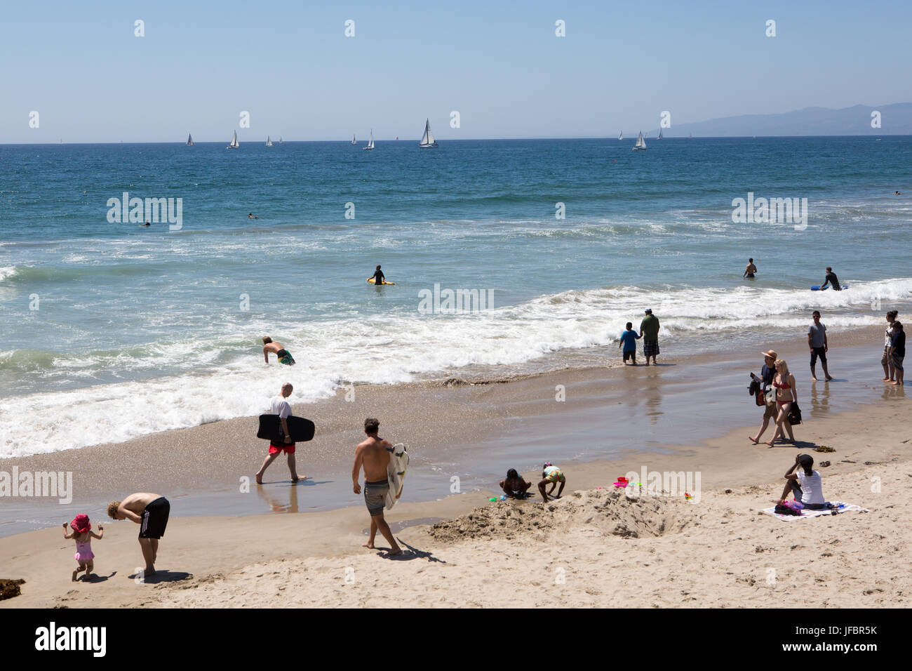 People enjoy sailing, surf, sand, ocean and sunshine at Venice Beach. Stock Photo