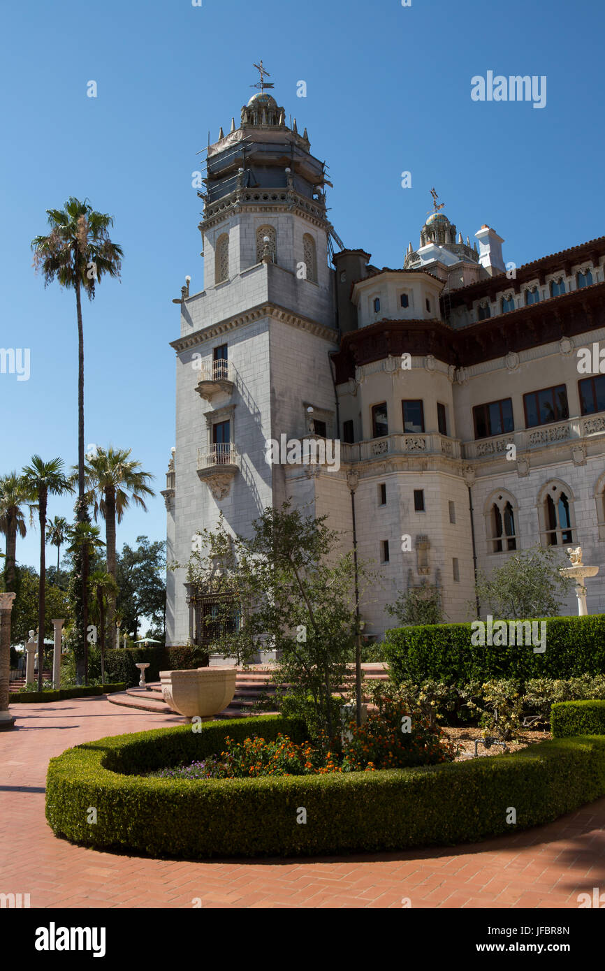 An exterior view of Hearst Castle and Casa Grande near palm trees. Stock Photo
