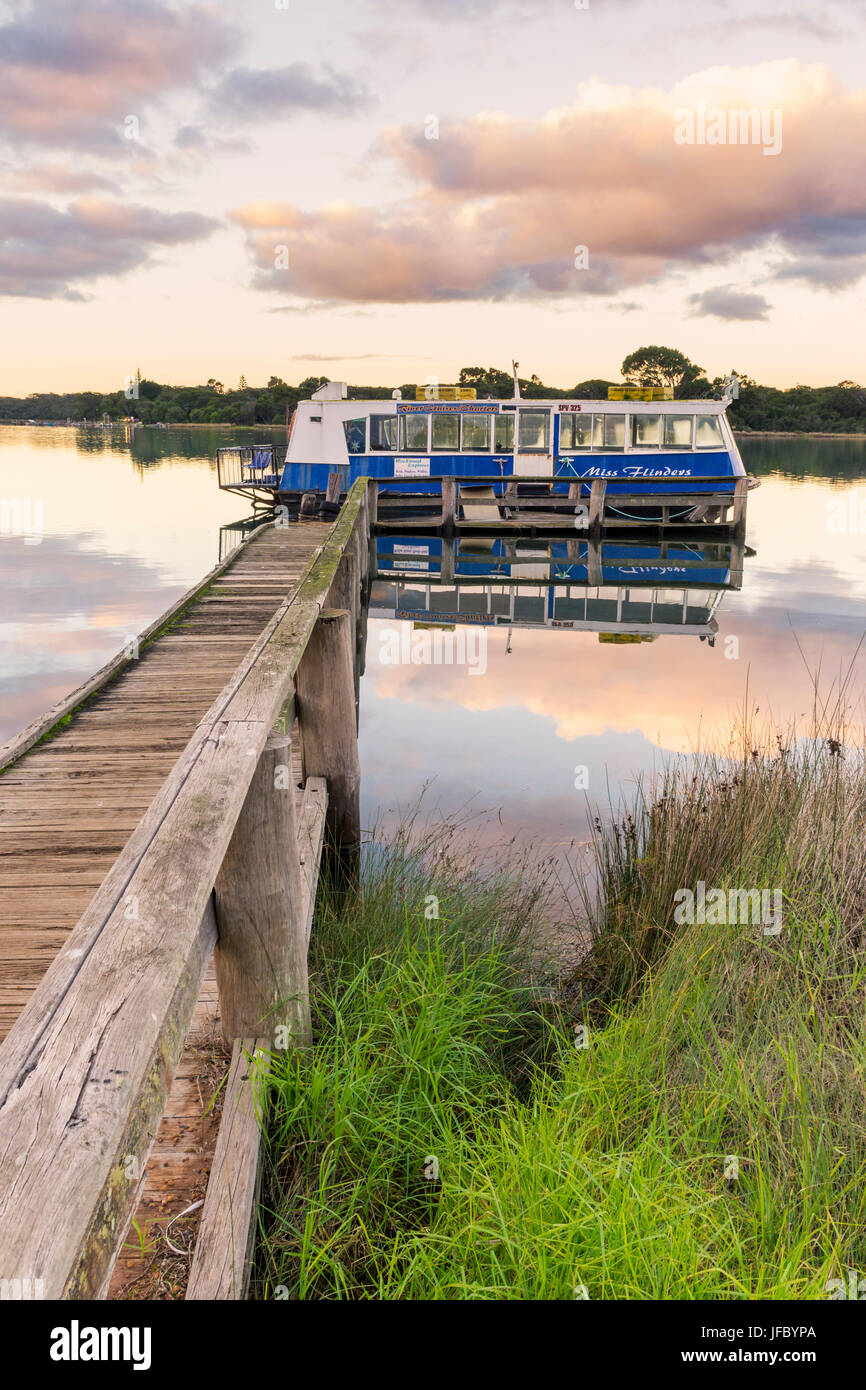 Miss Flinders tourist boat moored to a jetty on Hardy Inlet at sunset, Augusta, Western Australia Stock Photo