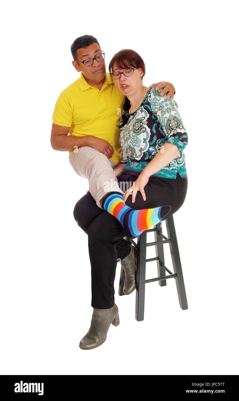 Woman smells the feet of her husband. Stock Photo