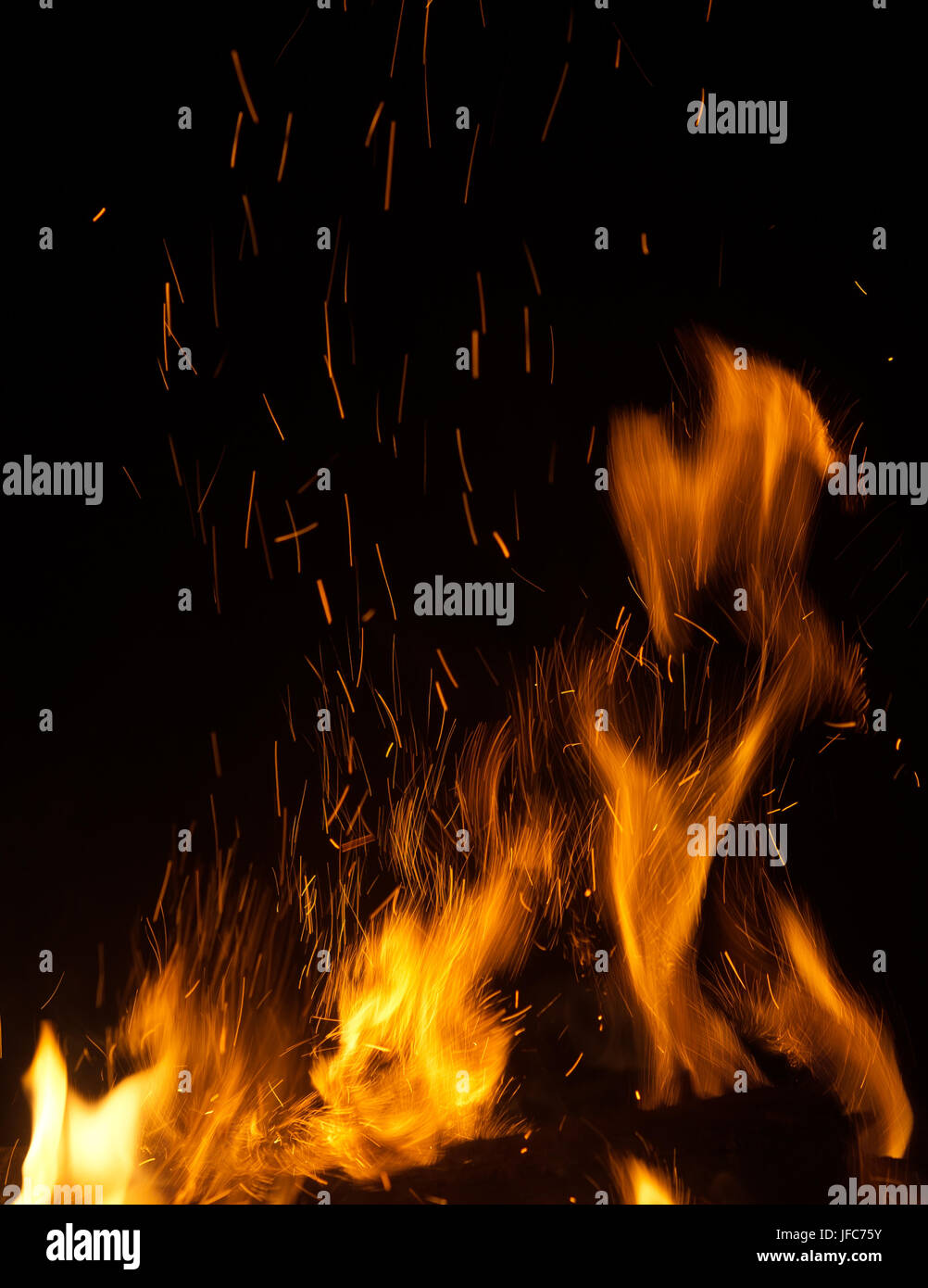 fire flames with sparks on black background Stock Photo - Alamy
