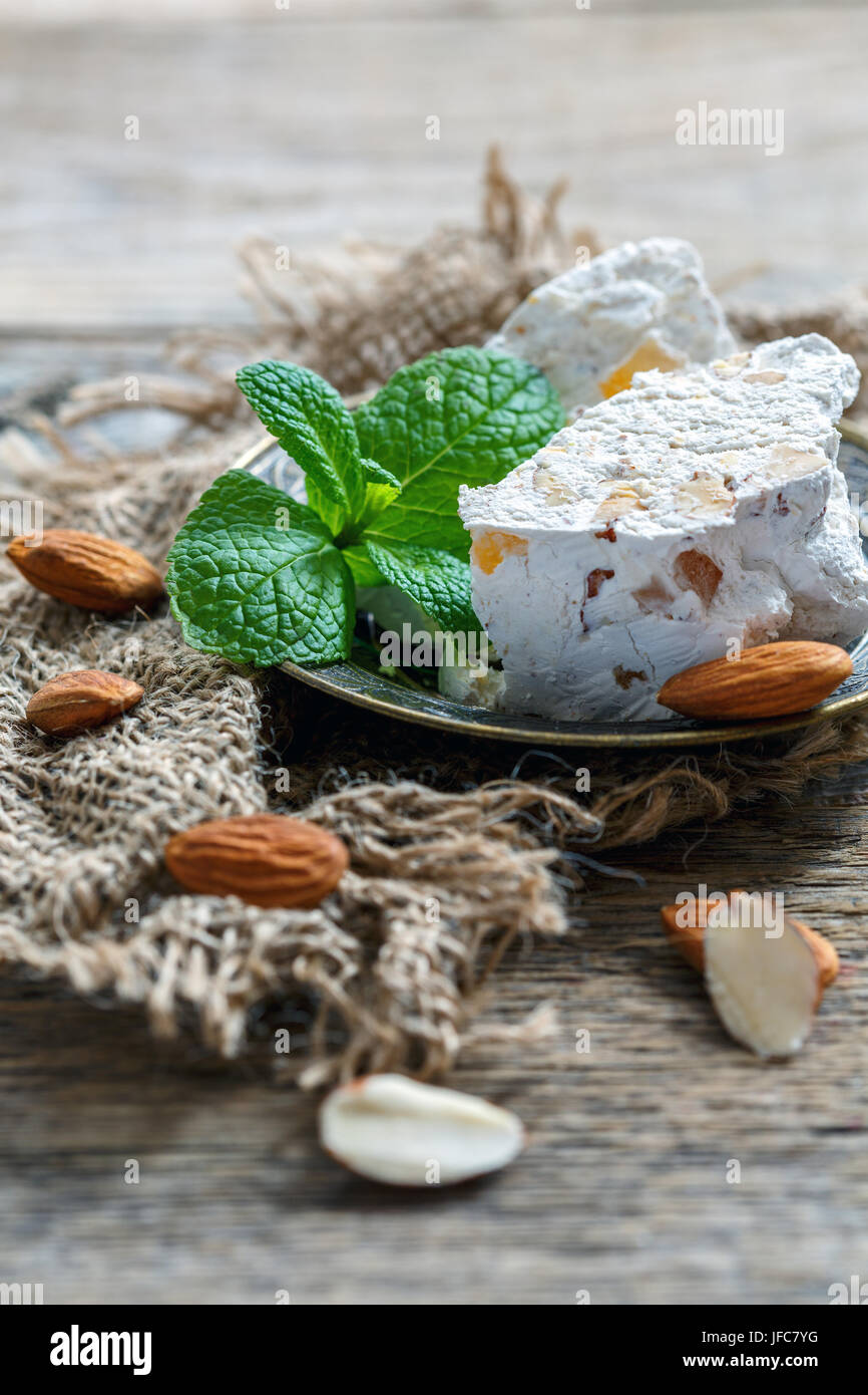 Nougat with almonds and candied fruit on a bronze plate Stock Photo Alamy