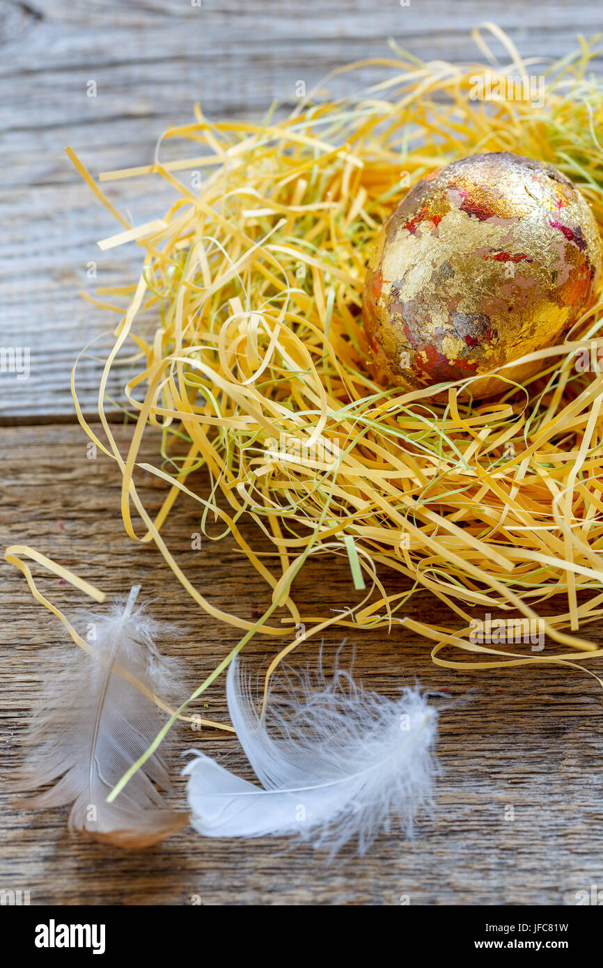 Golden egg in a nest Stock Photo - Alamy