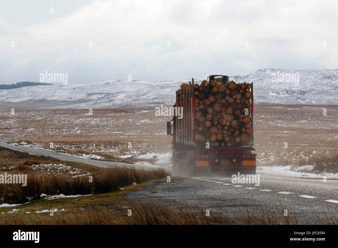 Haulage truck driving in extreme winter conditions on an icy road in Wales. Stock Photo