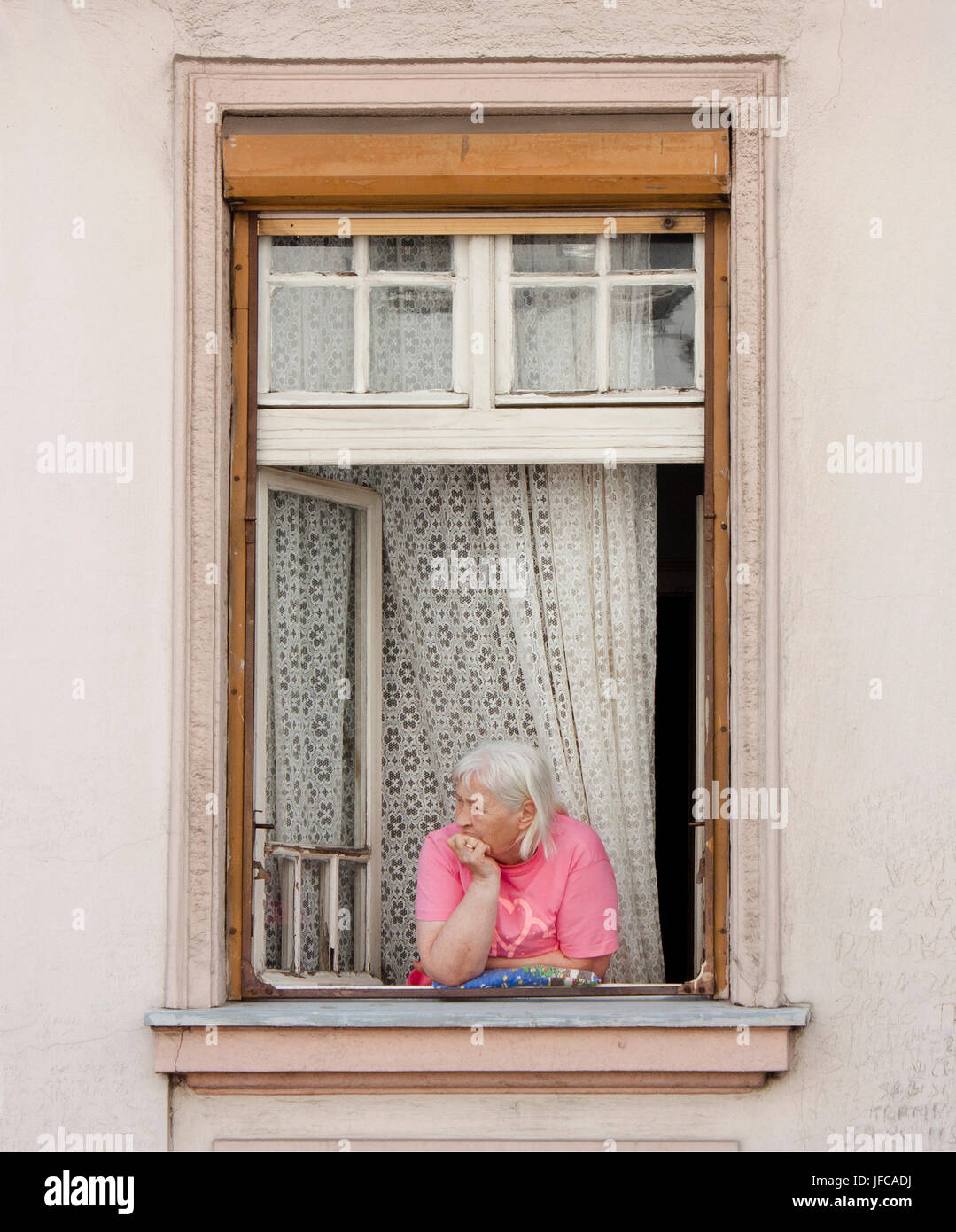 Senior woman looking out of the window Stock Photo