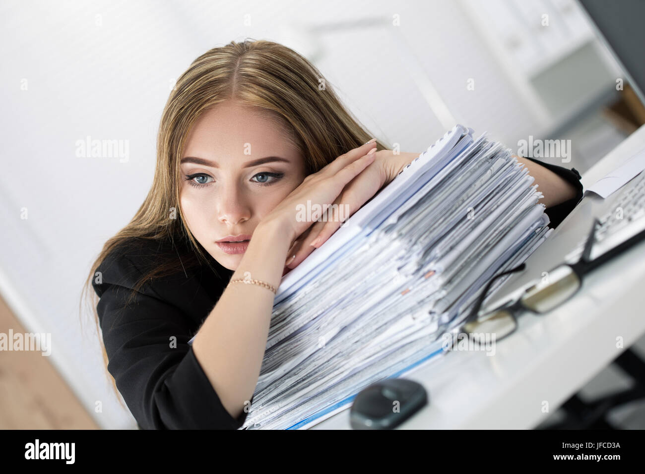 Tired Business Woman Laying On Heap Of Papers At Her Working Place