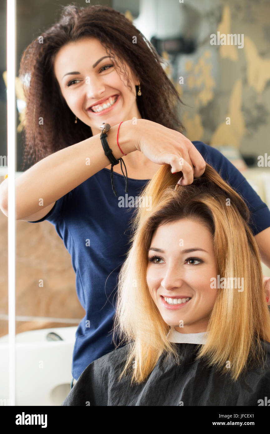 Female hairdresser and client deciding what haircut to do. Healthy hair, latest hair fashion trends, changing haircut style concept Stock Photo