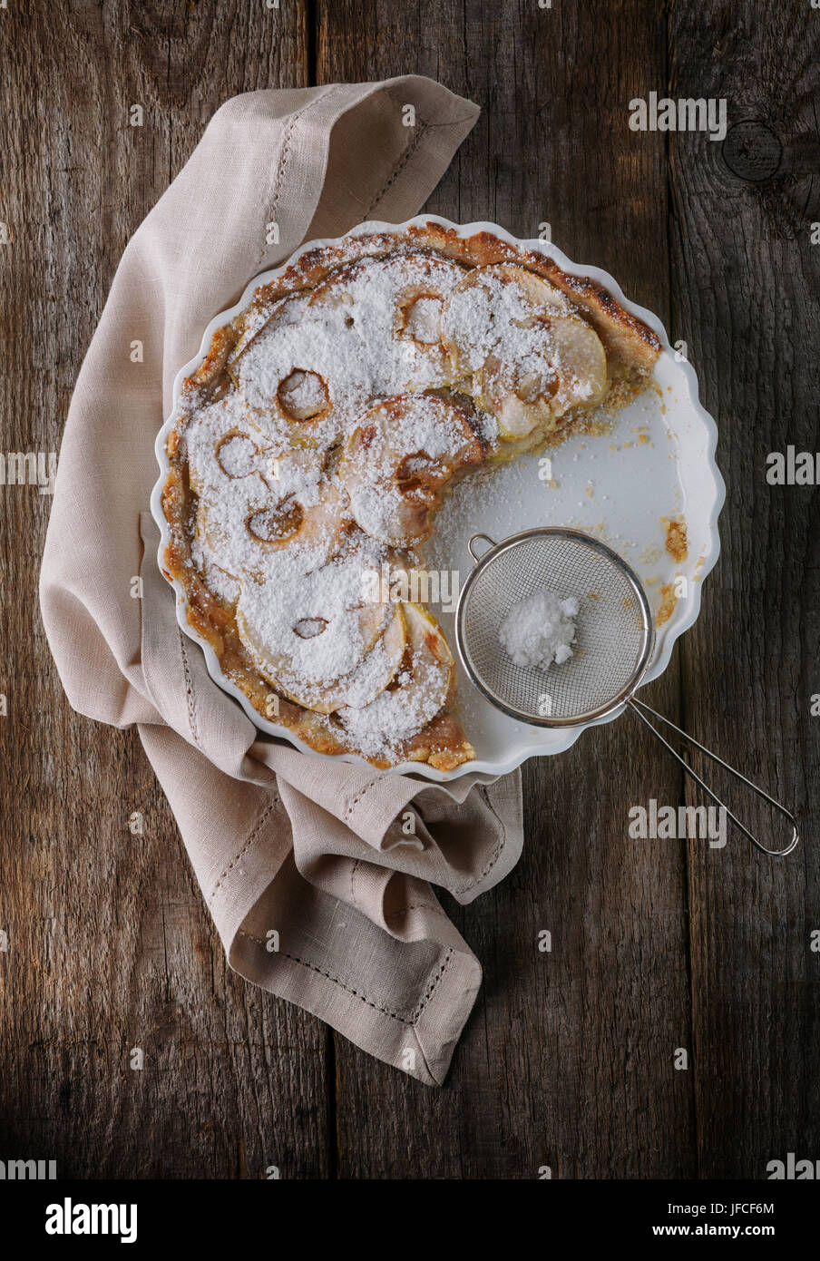 Apple pie and a napkin on wooden table. Stock Photo