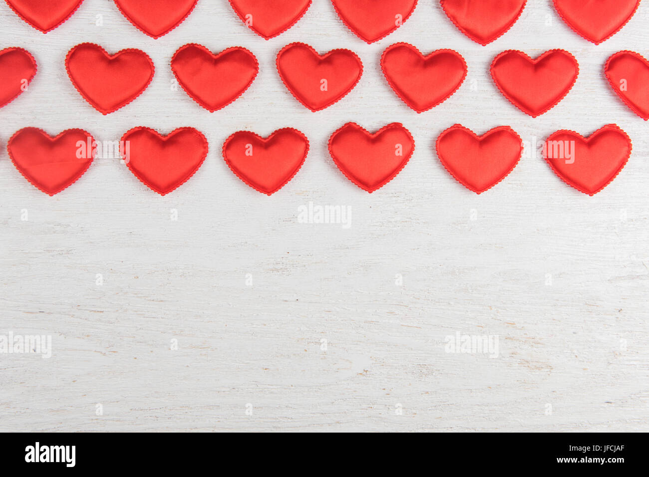 Red hearts on a white wood background Stock Photo - Alamy