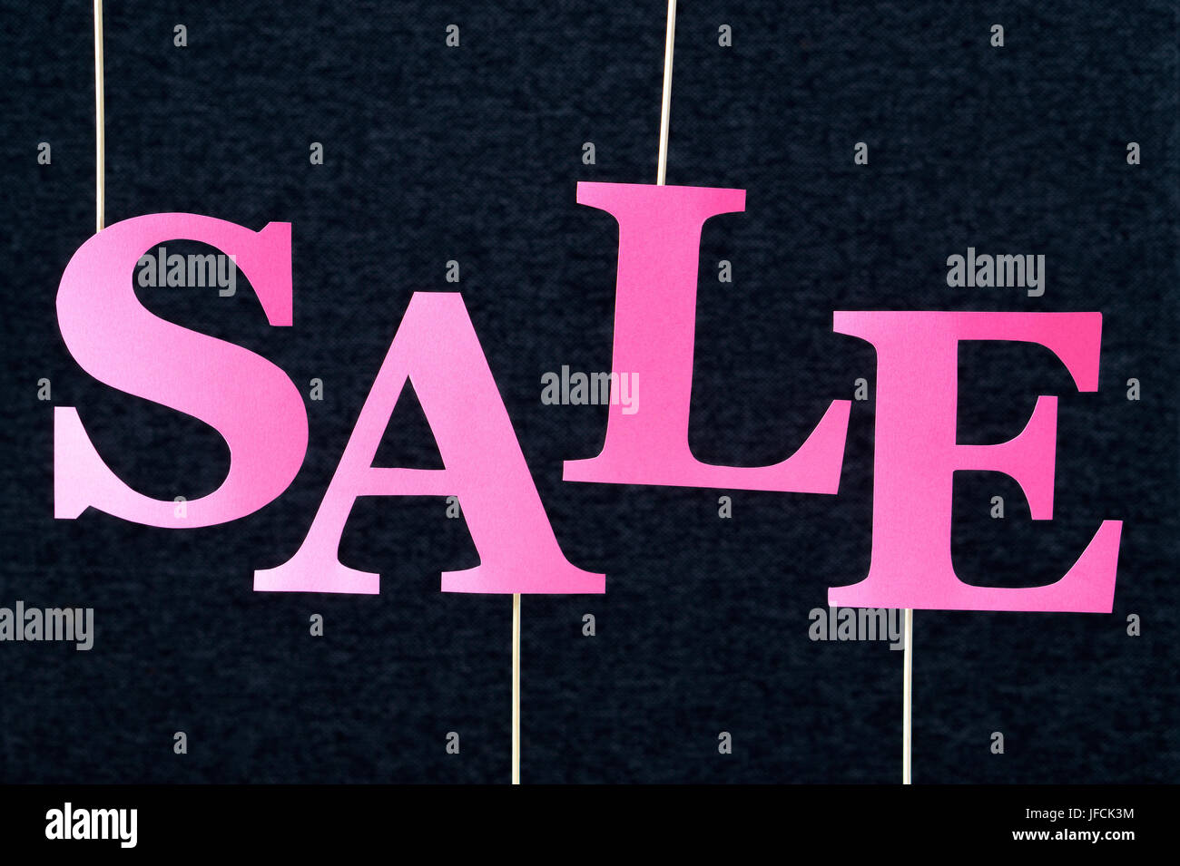 Fuchsia sale text on dark background. Pink red letters cut from cardboard  paper on wooden stick. Distinct design for promoting online shop discount  Stock Photo - Alamy