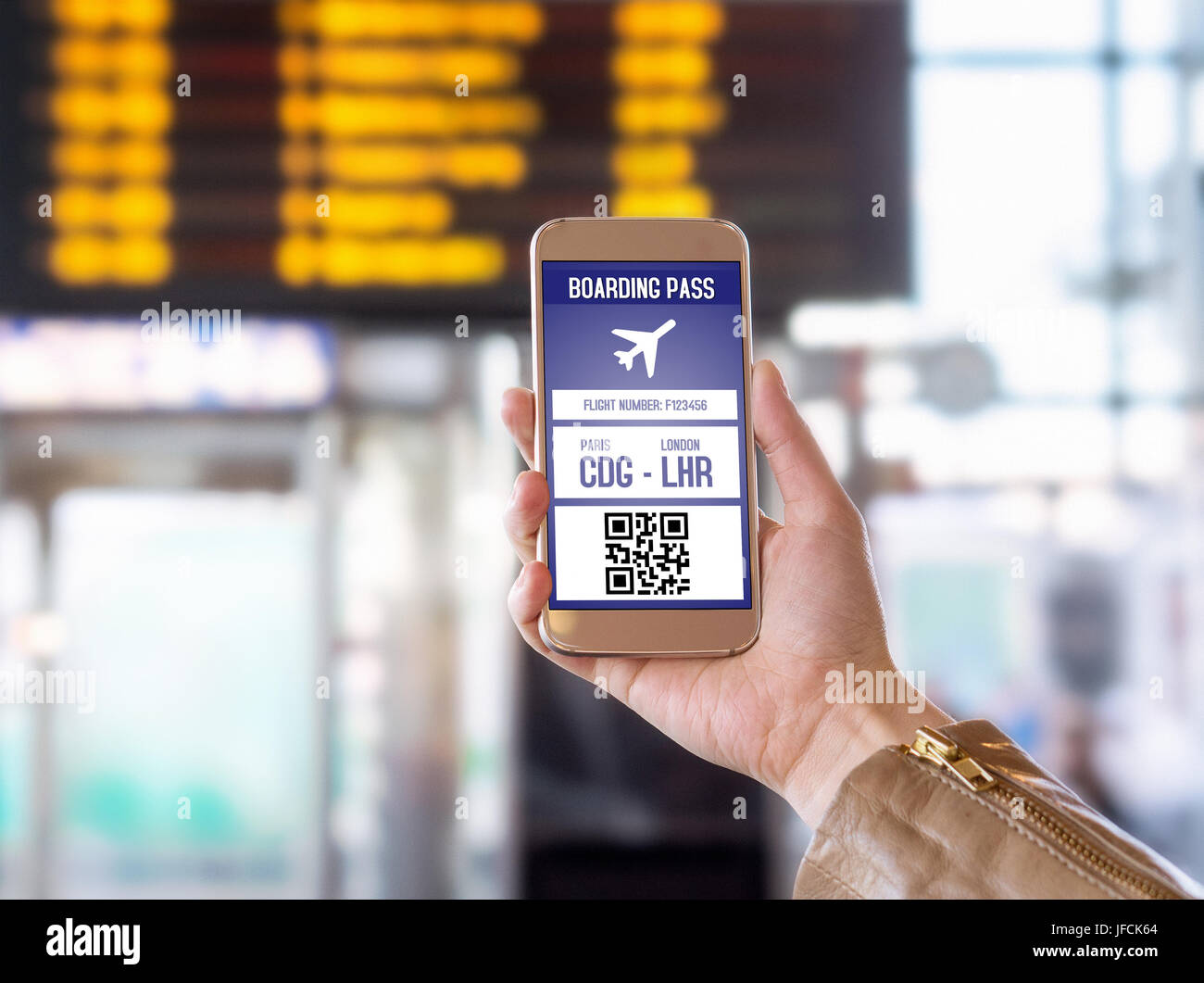 Boarding pass in mobile phone. Woman holding smartphone in airport with modern ticket on screen. Easy and fast access to aeroplane. Stock Photo
