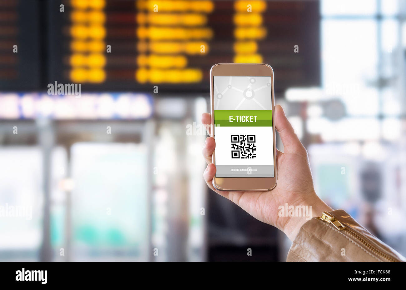 E-ticket on smartphone screen with timetable in the blurred background. Buying online ticket from internet. Universal public transportation terminal. Stock Photo