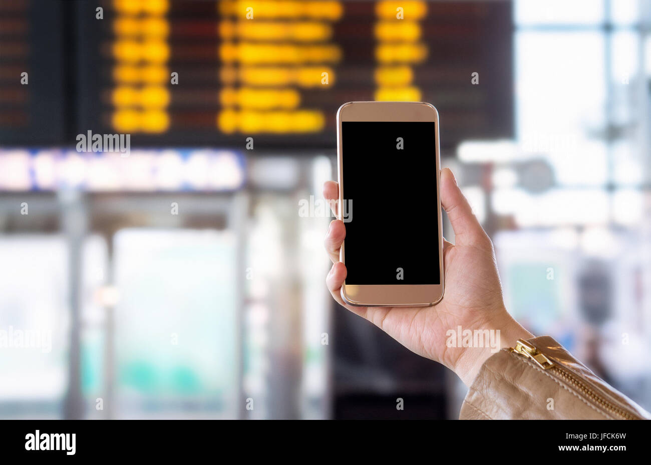 Smartphone with blank screen in bus, train, metro, subway or underground station or airport. Universal public transportation terminal. Stock Photo