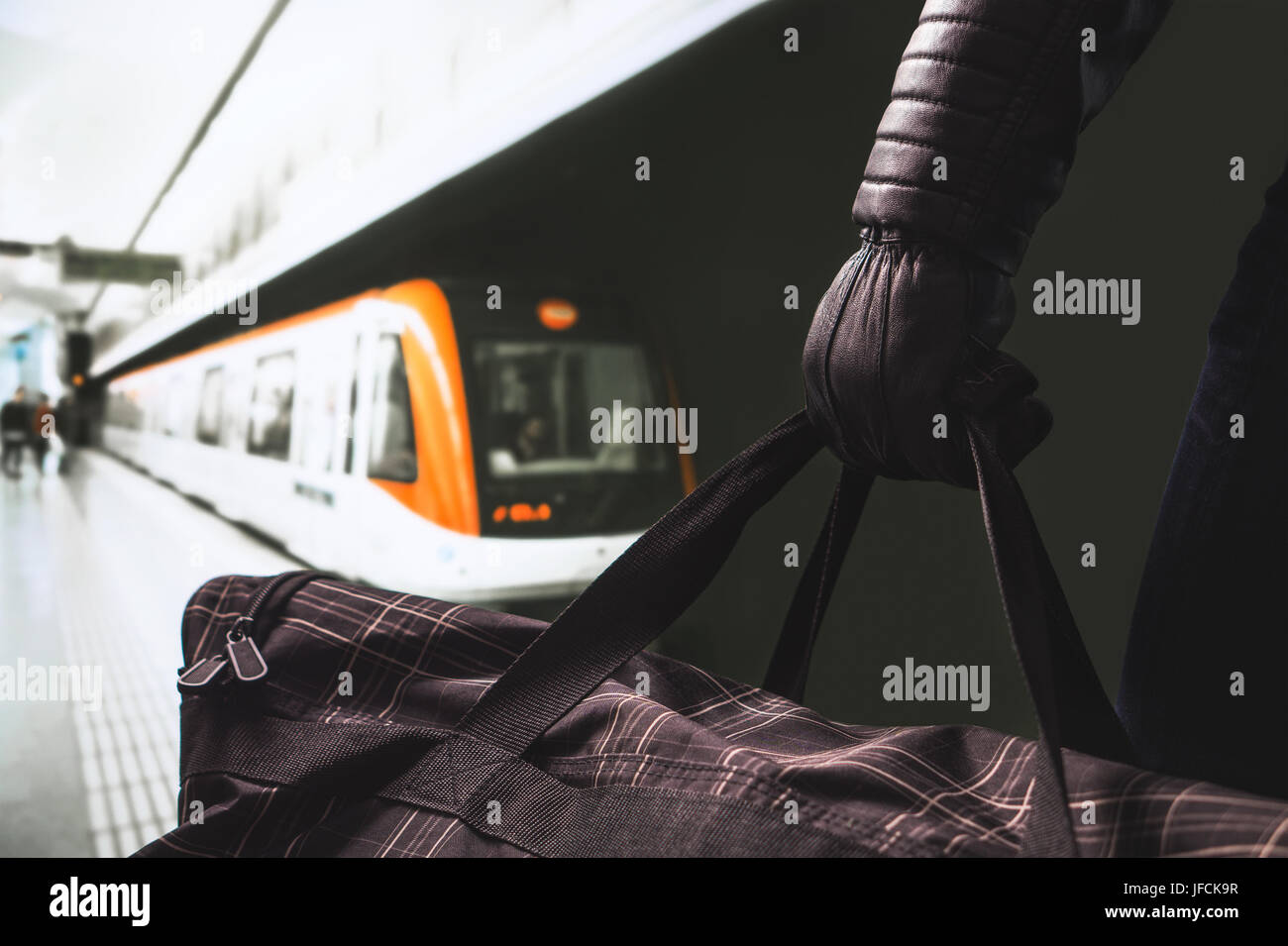 Terrorist in subway. Terrorism and security threat concept. Suspicious man in underground metro platform holding black bag. Planning a bomb attack. Stock Photo