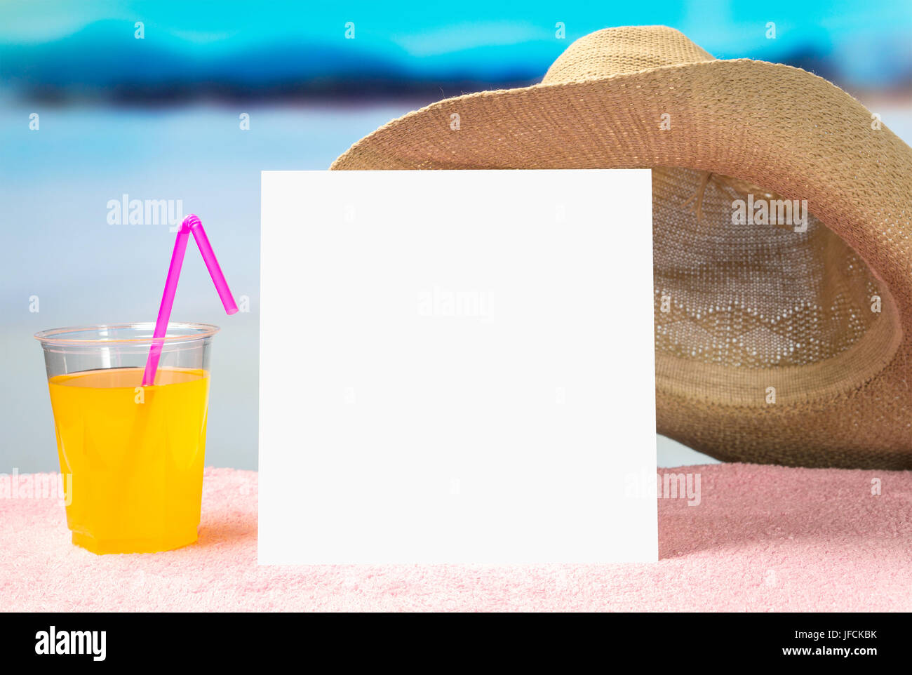 Summer sale or offer background for advertising. White square paper card on towel with sunglasses and yellow cocktail drink. Stock Photo