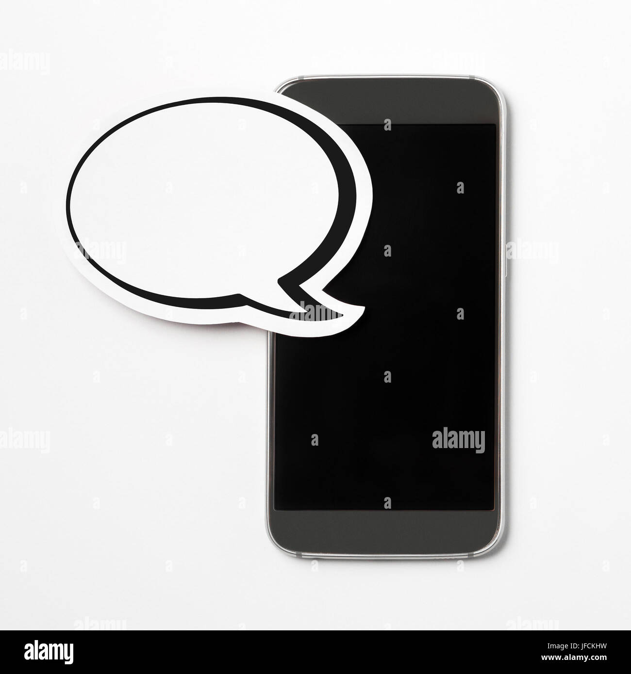 Blank speech bubble on a grey empty screen smartphone. Paper speech balloon and mobile phone. Perfect for website, social media, offer and promotion. Stock Photo