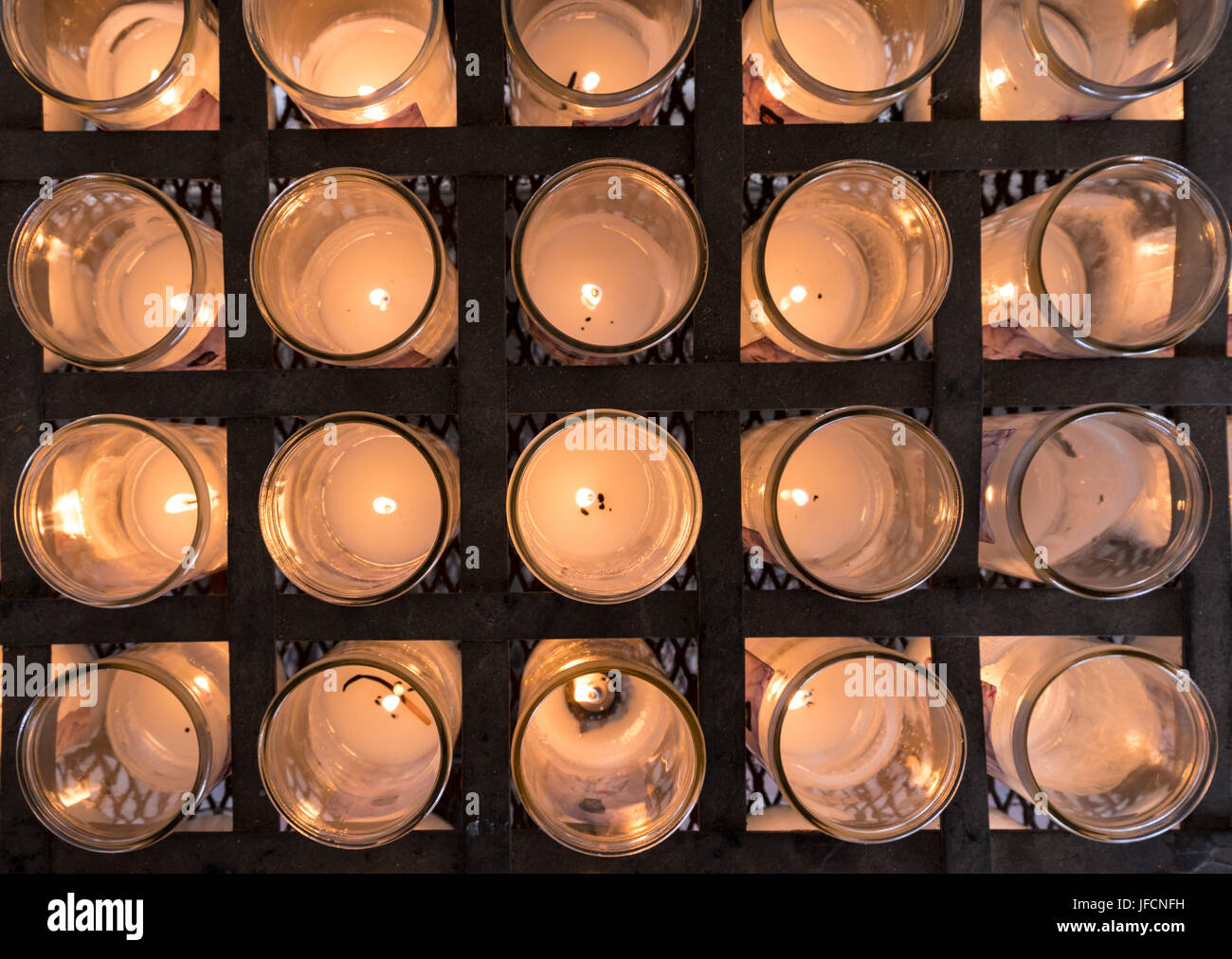 Rows of Votive candles in catholic church Stock Photo