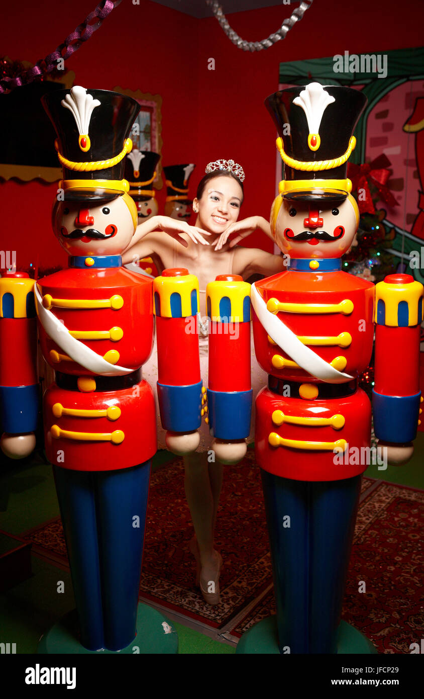 A ballerina performs in front of Christmas Nut Crackers, Stock Photo