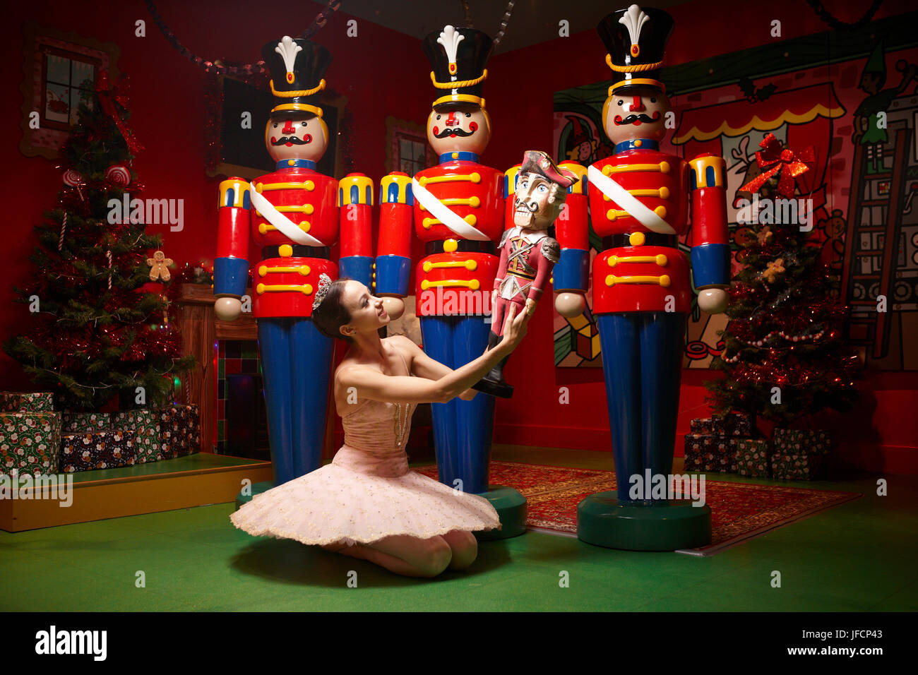 A ballerina performs in front of Christmas Nut Crackers, Stock Photo