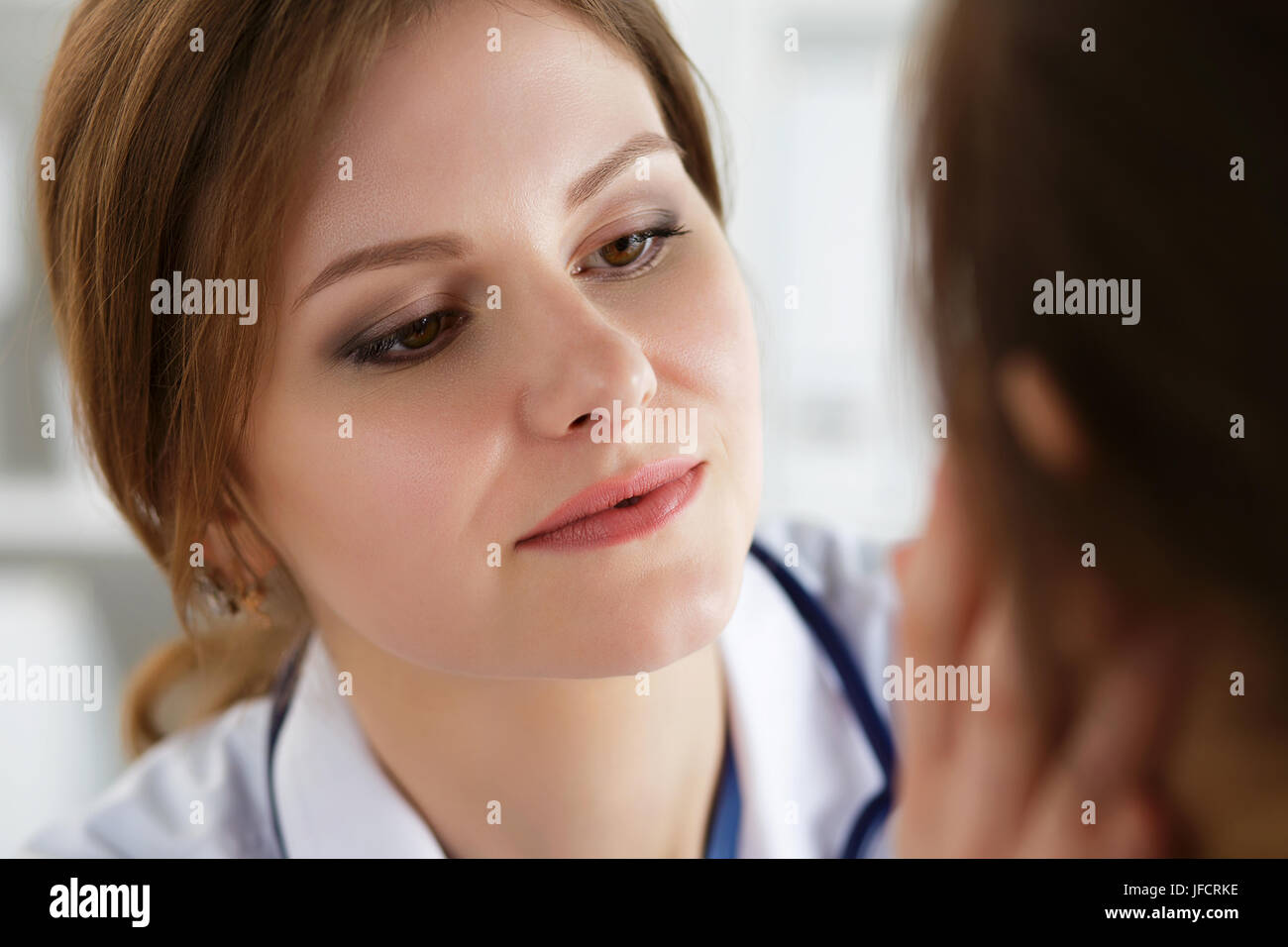 Female medicine doctor examining patient. Healthcare, medical service and insurance concept. Dermatologist or ENT examination. Stock Photo