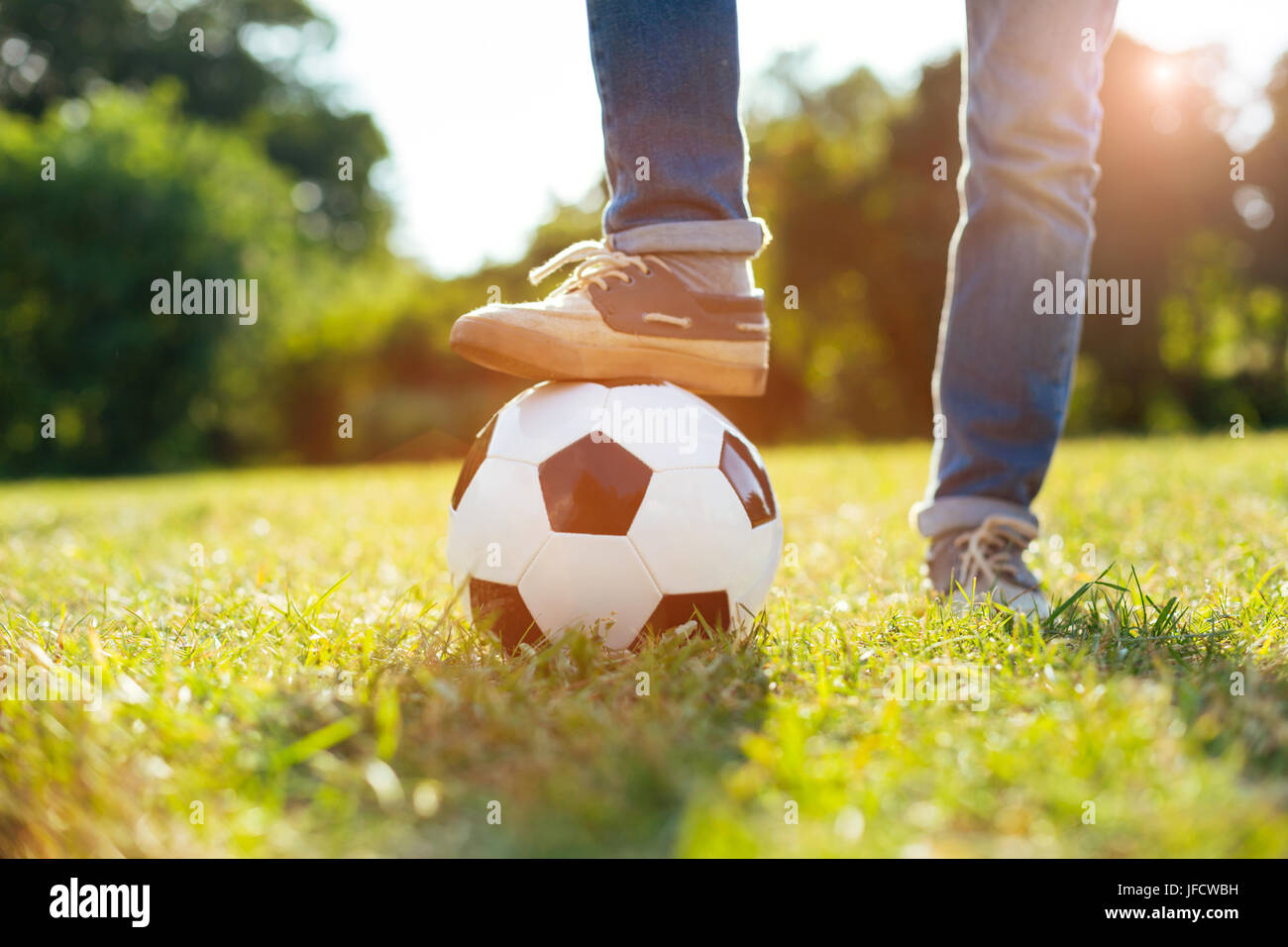 New hobby. Motivated dedicated healthy child playing football while going  outside for a walk and having an active leisure Stock Photo - Alamy