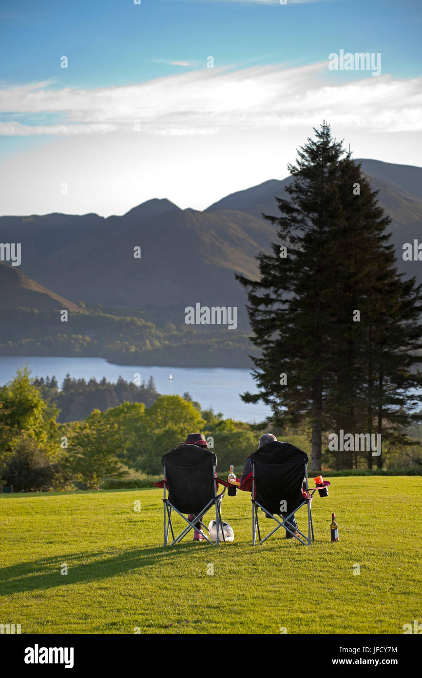 couple relaxing, Derwent water, Lake District, Cumbria, England Stock Photo