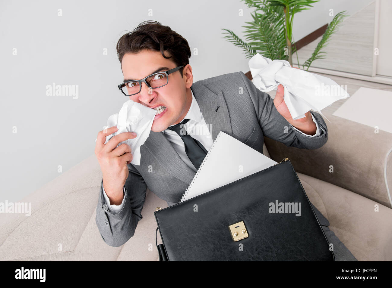 Angry businessman with crumbled paper Stock Photo