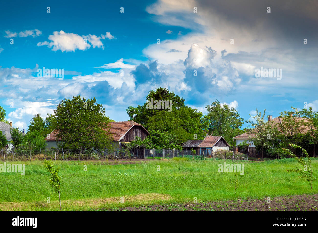 Small village and blue sky with clouds Stock Photo - Alamy