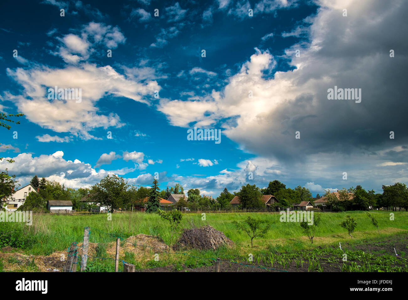 Small village and blue sky with clouds Stock Photo - Alamy
