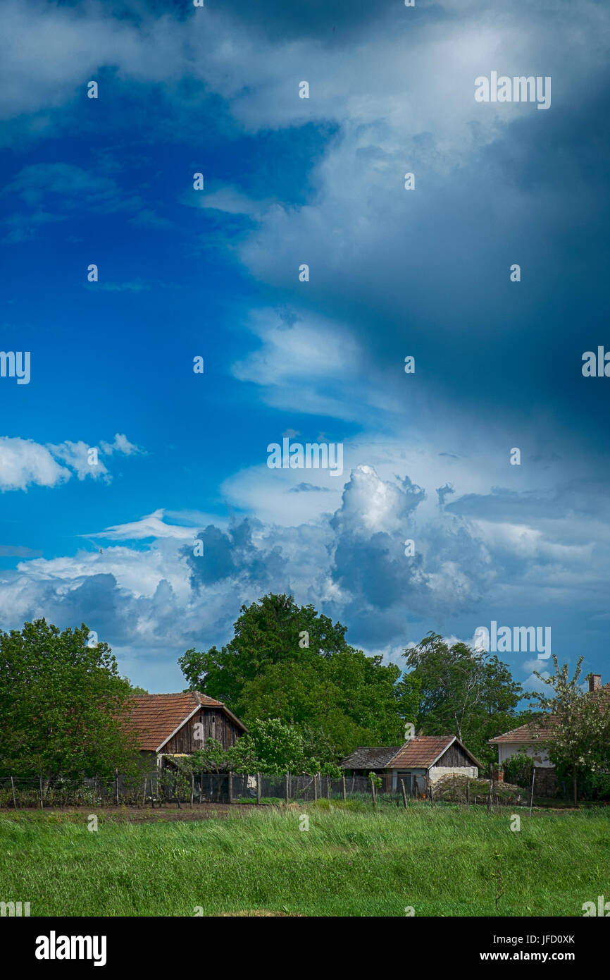 Small village and blue sky with clouds Stock Photo - Alamy