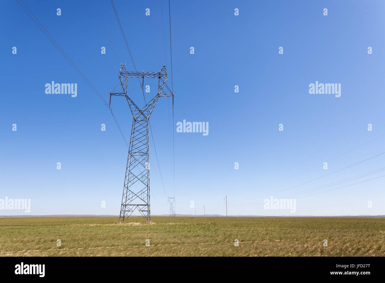 electricity transmission pylon in prairie Stock Photo