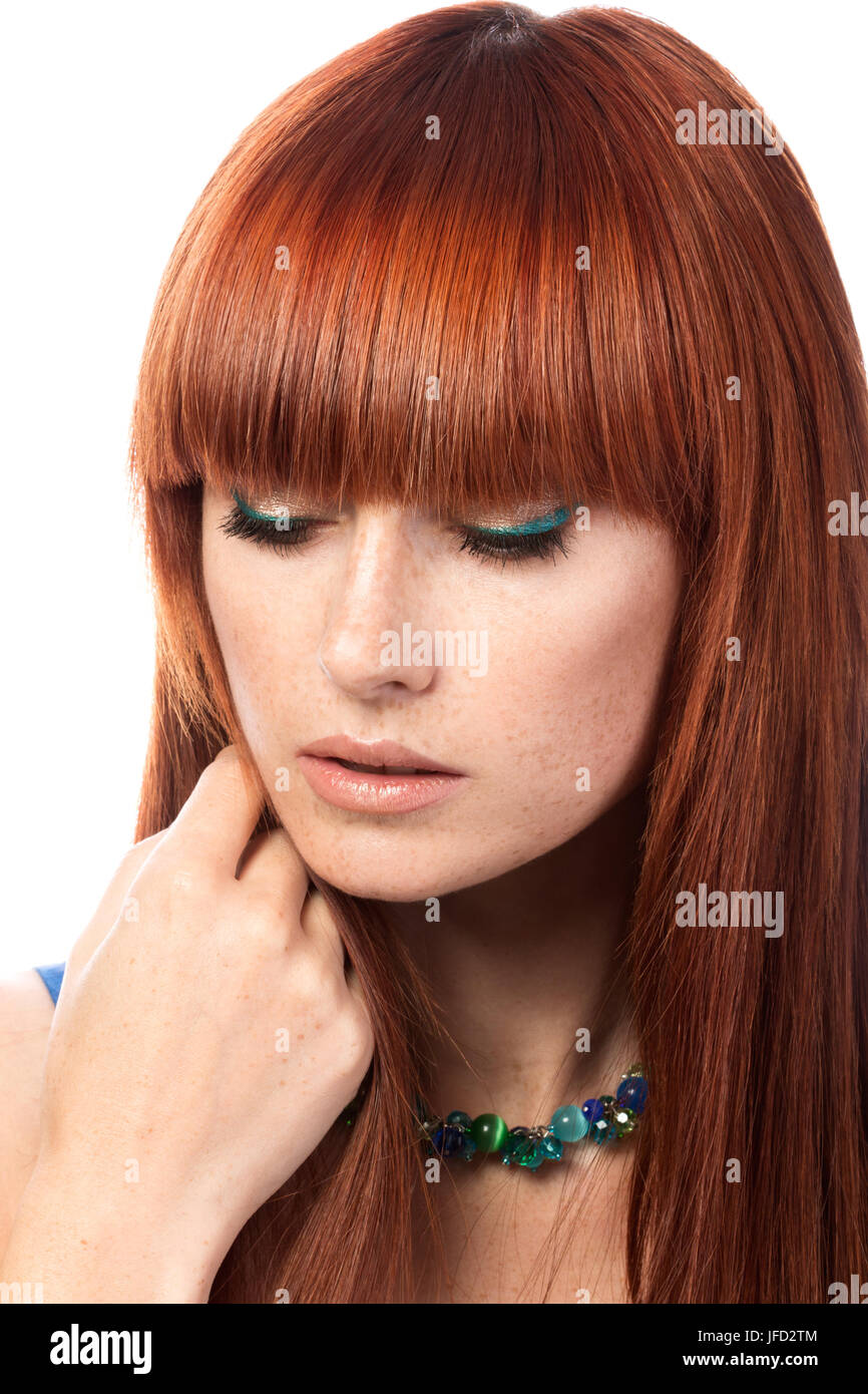 Portrait of young beautiful ginger woman touching her hair isolated