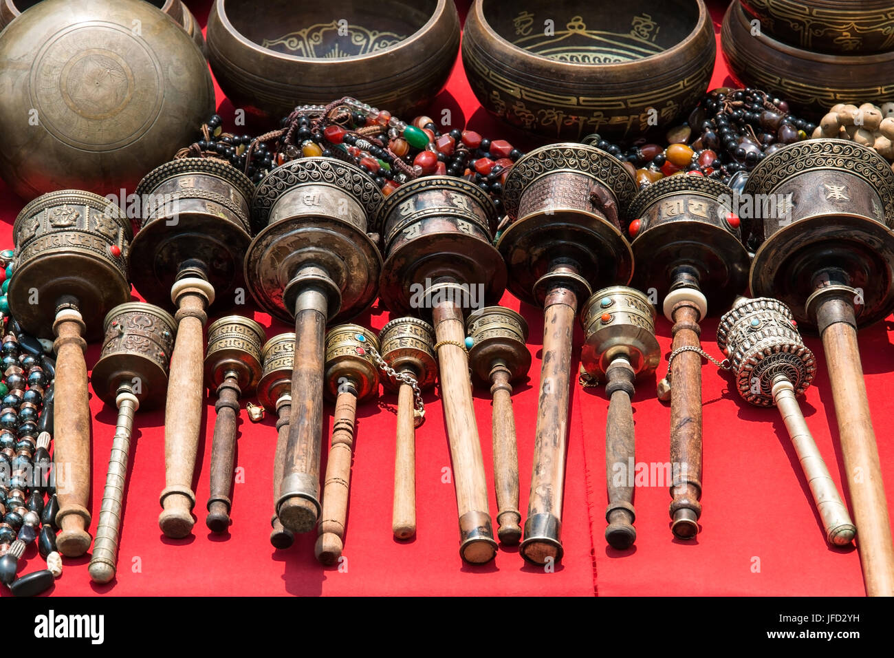 Bunch of tibetan traditional souvenirs lying on red table (market in