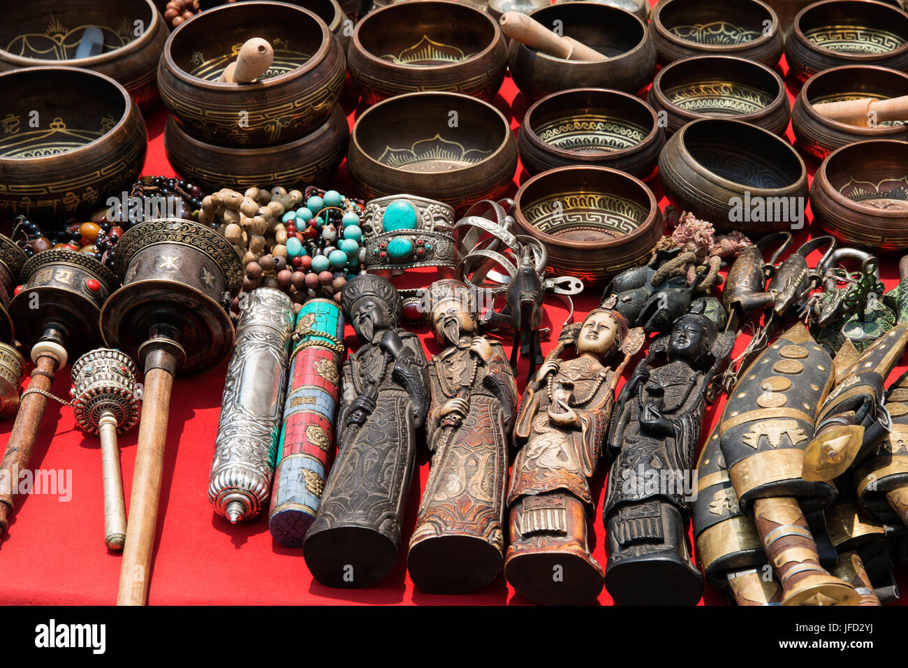 Bunch of tibetan traditional souvenirs lying on red table (market in Nepal, Kathmandu) Stock Photo