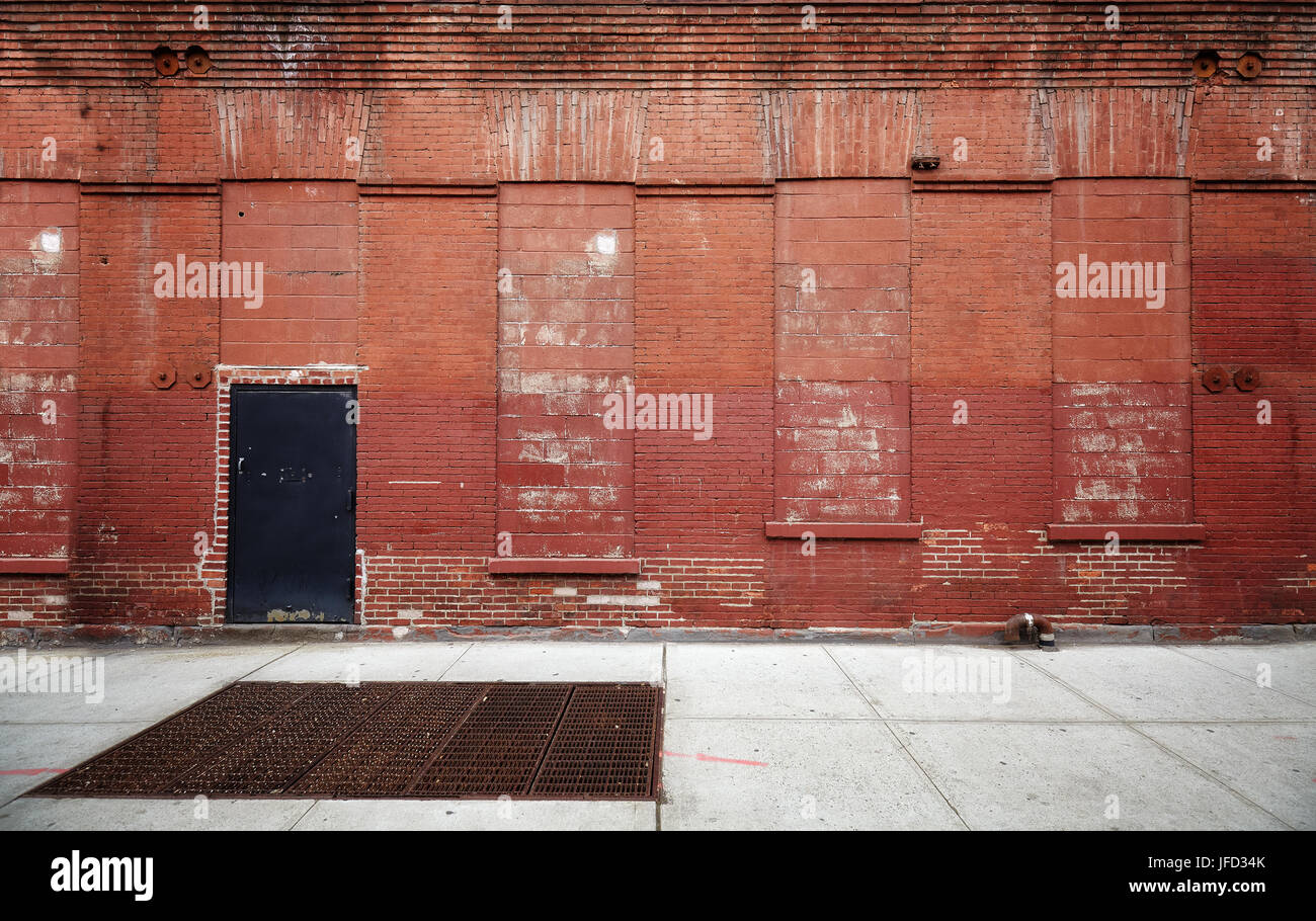 Empty street with old warehouse brick wall, industrial background, New
