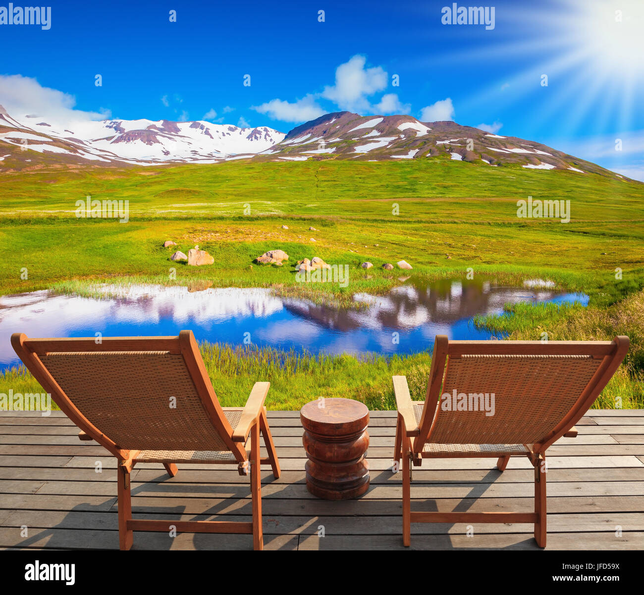 On wooden platform there are two deckchairs Stock Photo