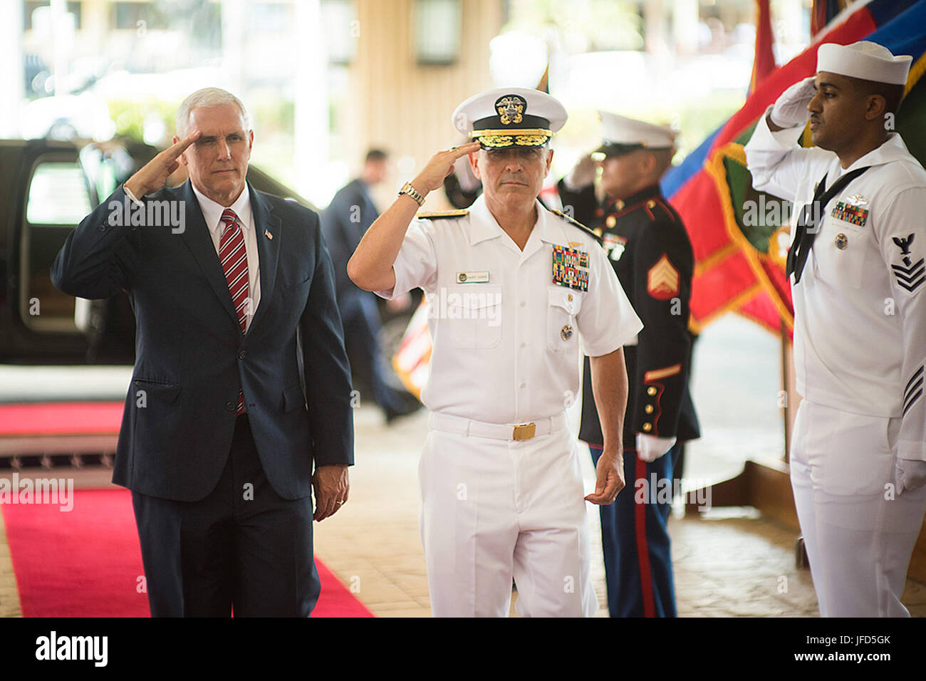 Vice President Mike Pence and Commander of U.S. Pacific Command, Adm. Harry B. Harris Jr., salute troops upon the Vice President’s arrival at Joint Base Pearl Harbor-Hickam in Hawaii, Monday April 24, 2017. (Official White House Photo by Myles Cullen) Stock Photo