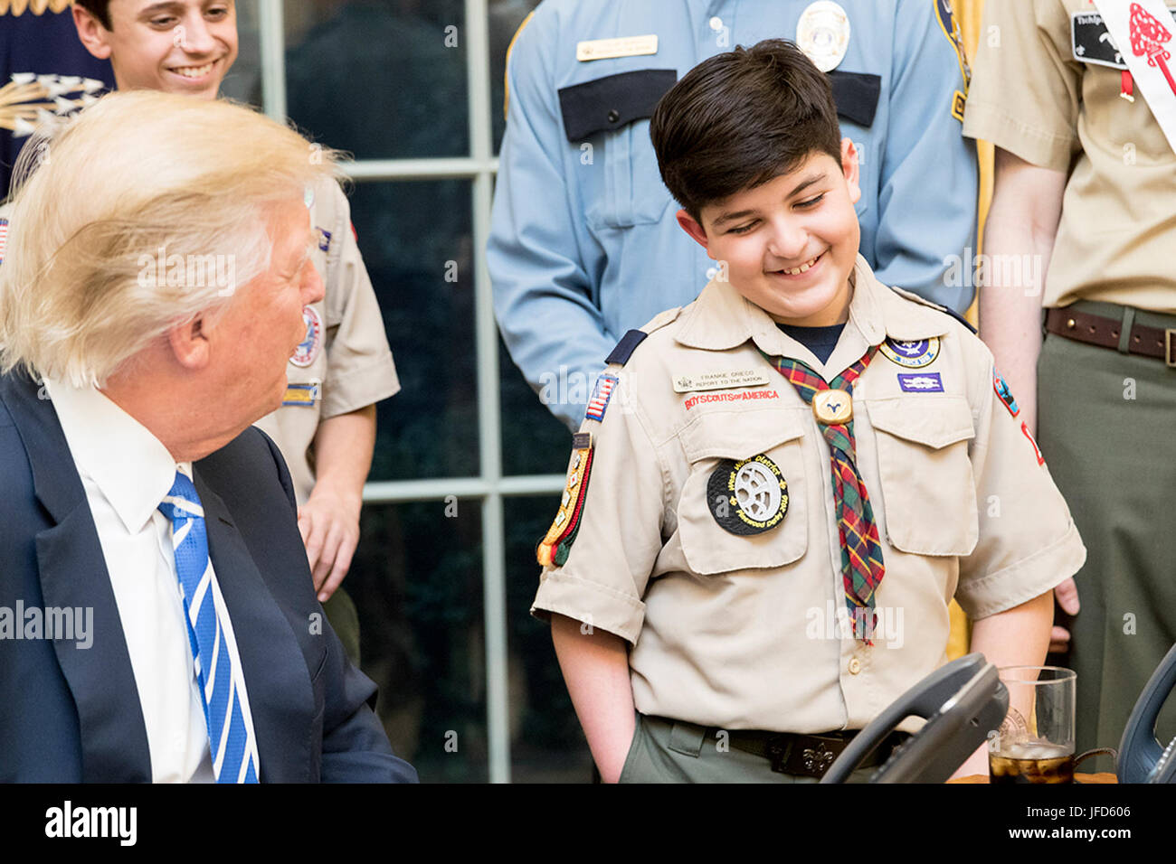 President Donald Trump shares a laugh with a member of the Boy Scouts of America, Tuesday, March 7, 2017, in the Oval Office. (Official White House Photo by Shealah Craighead) Stock Photo