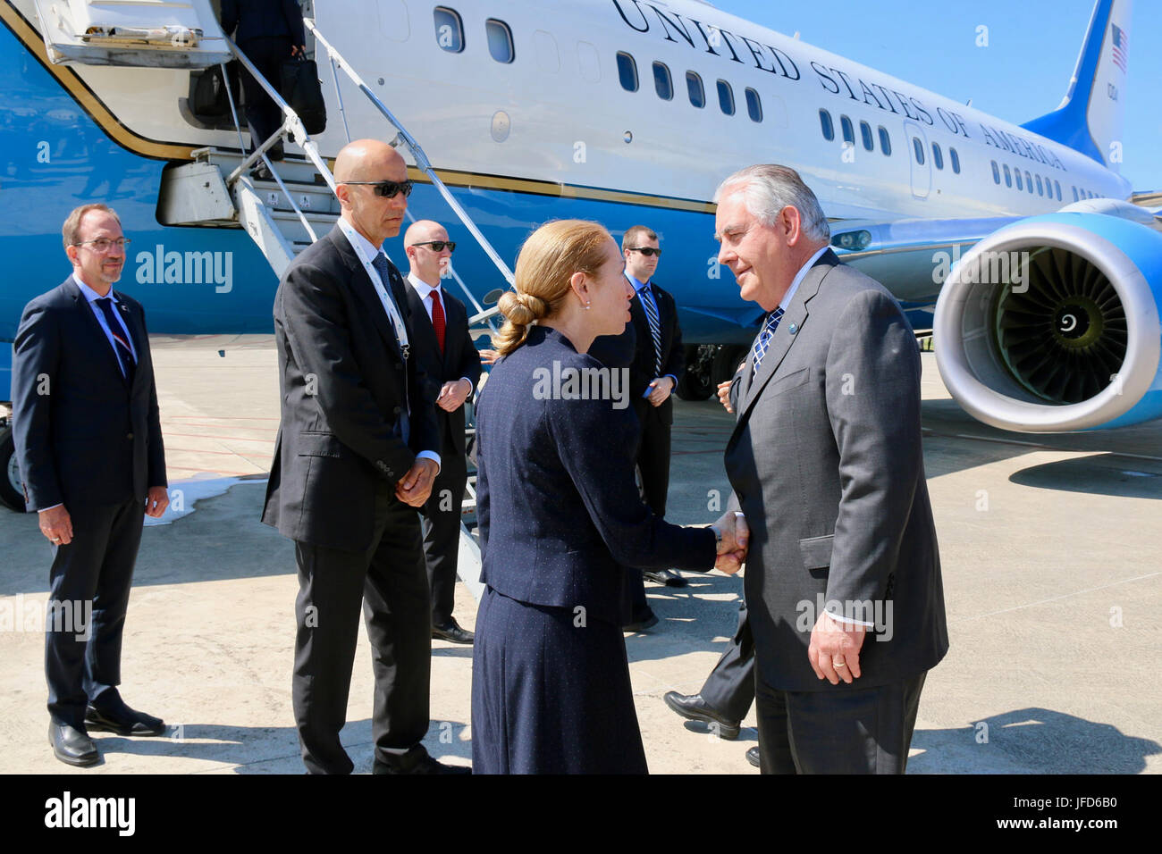 U.S. Secretary of State Rex Tillerson shakes hands with Kelly Degnan, Chargé d’Affaires ad interim of the U.S. Embassy in Rome, Italy, before departing Pisa Military Airport en route to Moscow, Russia, on April 11, 2017. Stock Photo