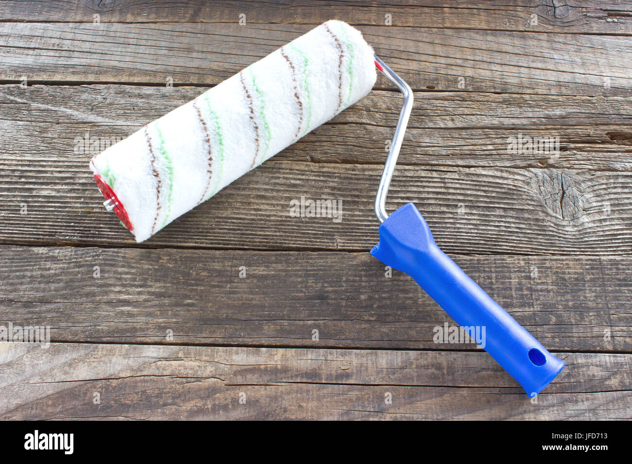 Painting roller on wooden background Stock Photo