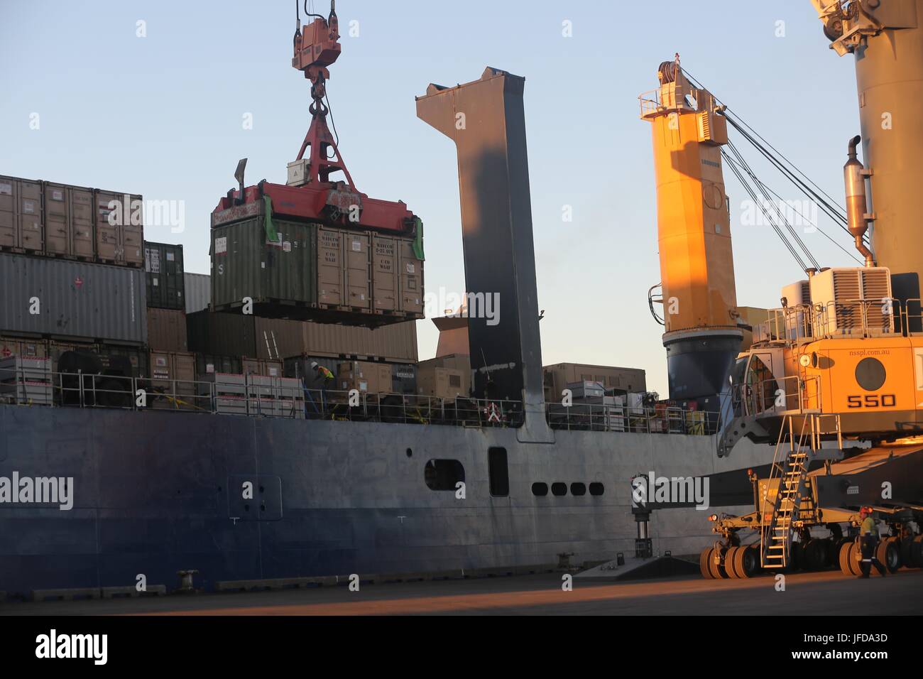 Crane offloads shipping containers hi-res stock photography and images ...