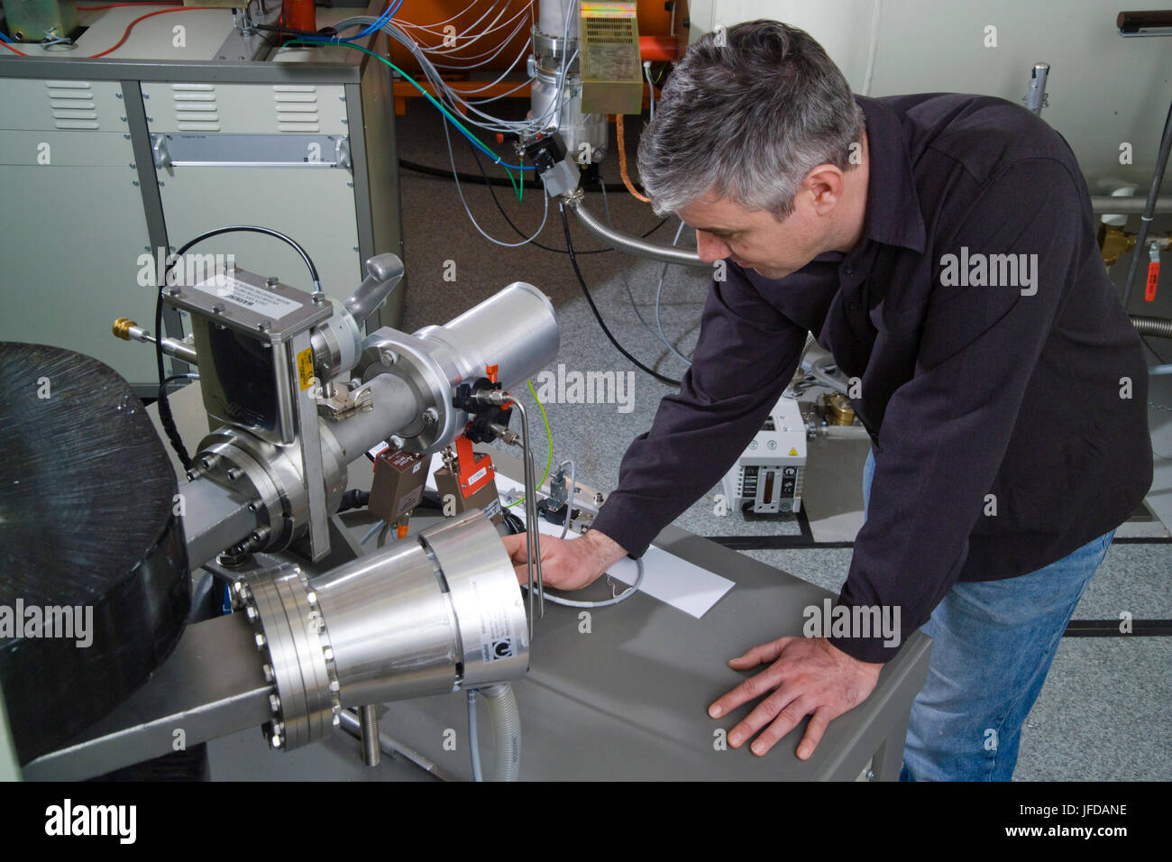 Scientist checks the final stage detector of the accelerator mass spectrometer which measures the carbon isotope ratios for radiocarbon dating. Stock Photo