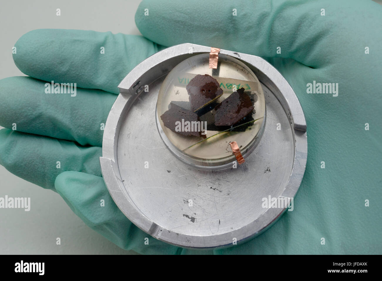 9th Century Syrian pottery fragments in the specimen holder of a Scanning Electron Microscope. Stock Photo