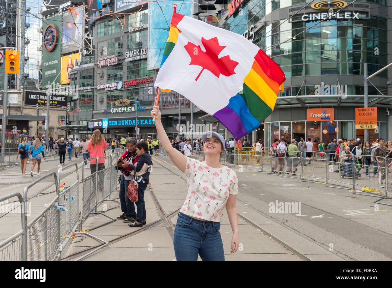 Toronto, Canada - 25 June 2017: Young girl waves canadian gay rainbow flag after Toronto Pride Parade Stock Photo