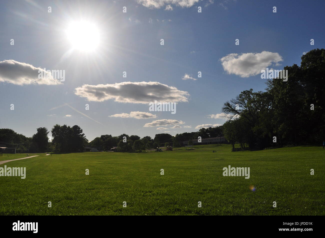 Scenic of sun clouds and grass Stock Photo